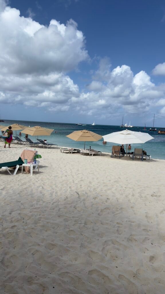 Palapa Aruba beach umbrella and two chairs set up on Eagle Beach